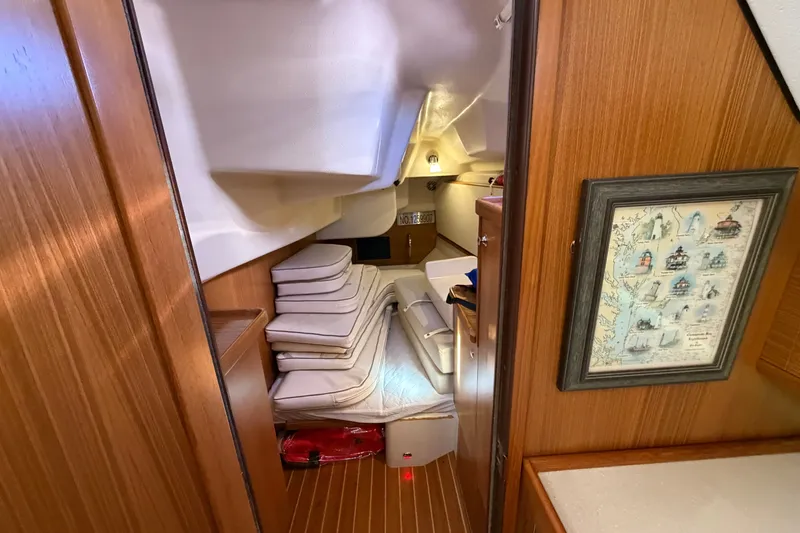 Slide: The Image of Interior of 2014 Catalina 445 sailboat with wooden paneling and cozy seating area. - 52