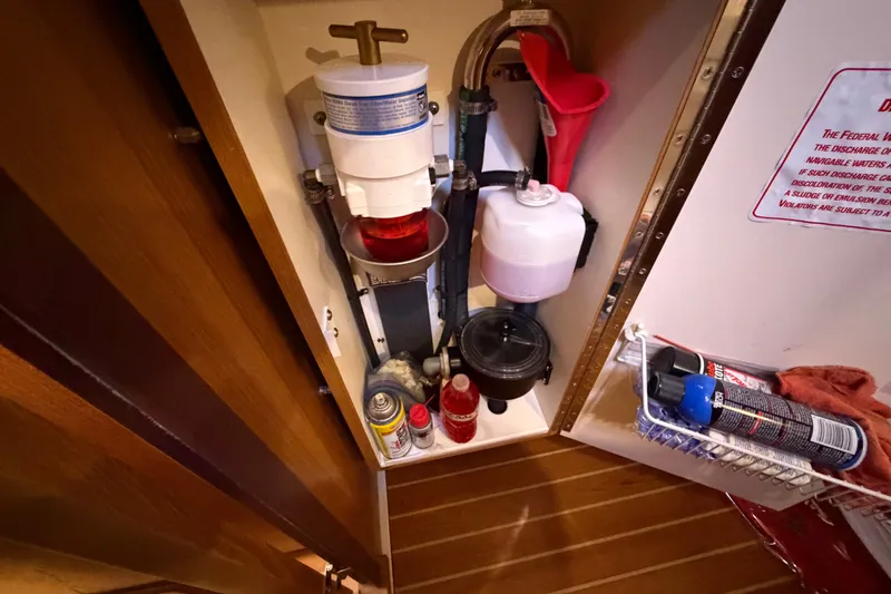 Slide: The Image of Engine compartment of a 2014 Catalina 445 sailboat with maintenance supplies. - 54