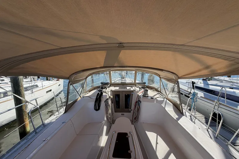 Slide: The Image of Cockpit view of a 2014 Catalina 445 sailboat with canopy and marina background. - 26