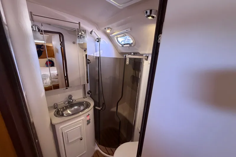 Slide: The Image of Compact bathroom in a 2014 Catalina 445 yacht with sink, mirror, and shower. - 58
