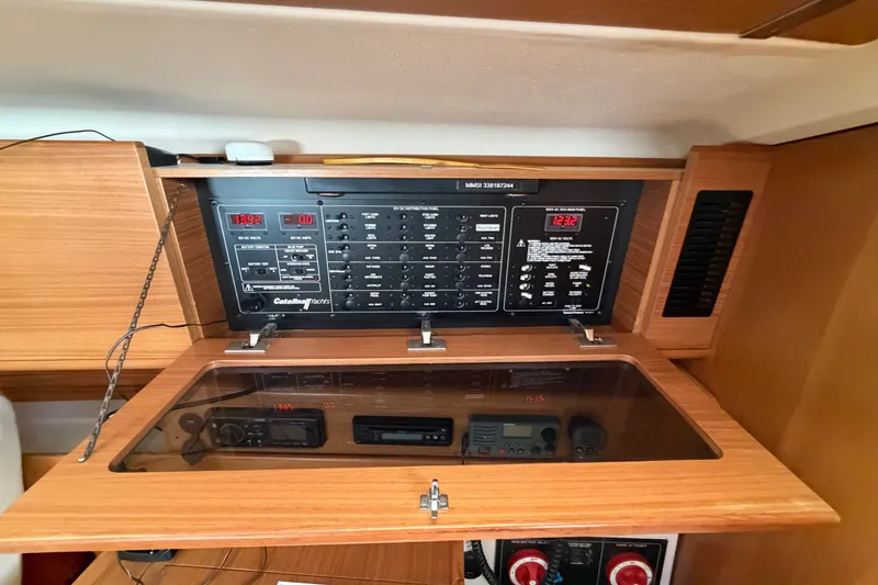 Slide: The Image of Electrical control panel inside a 2014 Catalina 445 sailboat, featuring various switches and displays. - 38