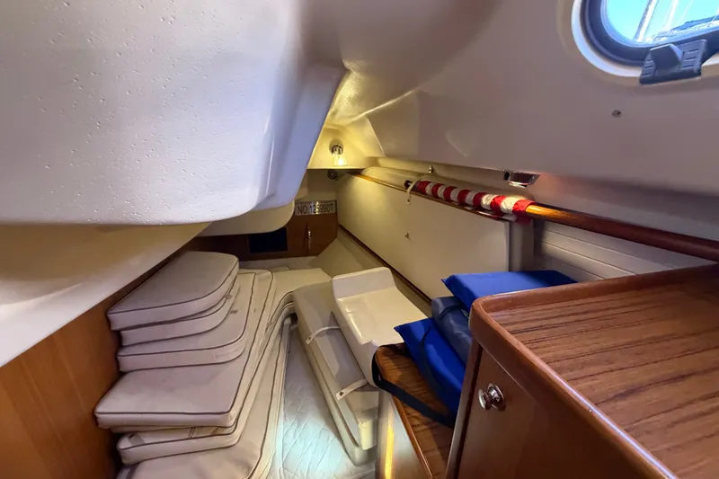 Slide: The Image of Interior cabin of a 2014 Catalina 445 sailboat with cushions and storage. - 53
