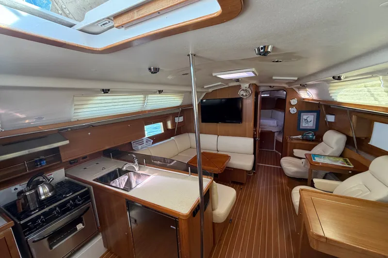 Slide: The Image of Luxurious interior of a 2014 Catalina 445 yacht with modern kitchen and seating area. - 28