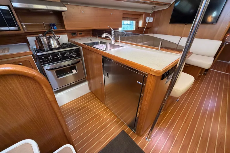 Slide: The Image of Modern kitchen interior of 2014 Catalina 445 yacht with wood finish and stainless appliances. - 30