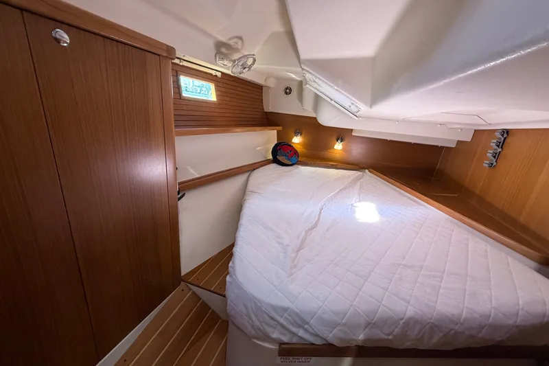 Slide: The Image of Cozy cabin interior of a 2014 Catalina 445 sailboat with a neatly made bed. - 51