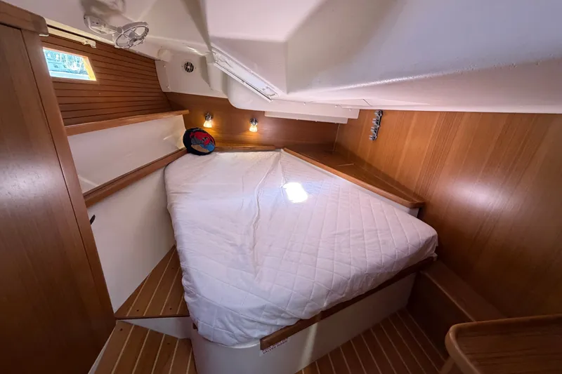 Slide: The Image of Cozy cabin interior of 2014 Catalina 445 sailboat with wooden accents and comfortable bedding. - 50