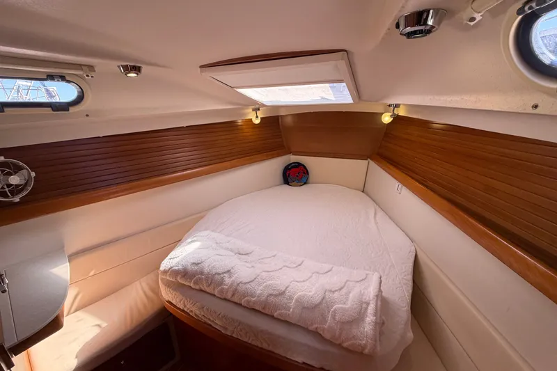 Slide: The Image of Cozy cabin interior of a 2014 Catalina 445 sailboat with wooden accents and a skylight. - 55