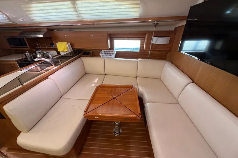 Slide: The Image of Interior of 2014 Catalina 445 yacht with cozy seating and wooden table. - 43