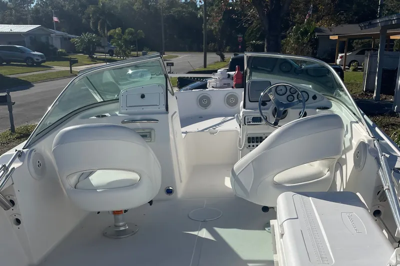 Slide: The Image of The image shows the cockpit of a 2011 Tidewater 196 DC Explorer with white seats and a helm. - 2