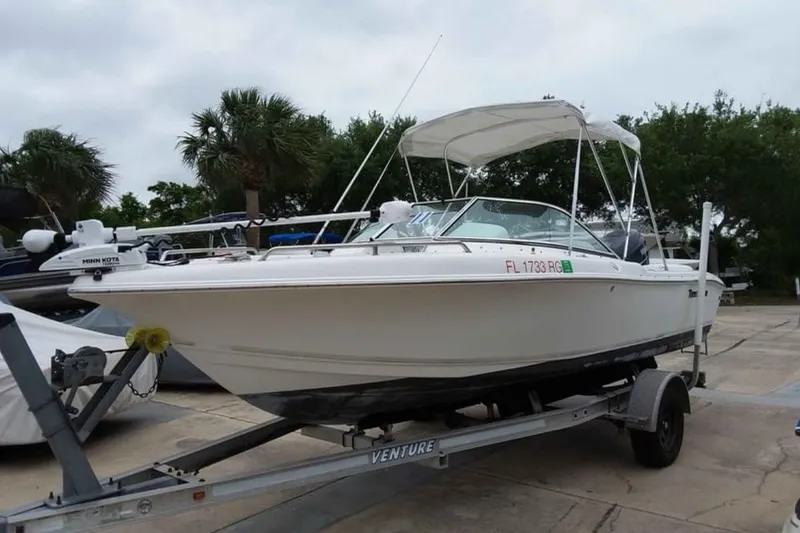 Slide: The Image of 2011 Tidewater 196 DC Explorer boat on trailer, parked outdoors. - 0