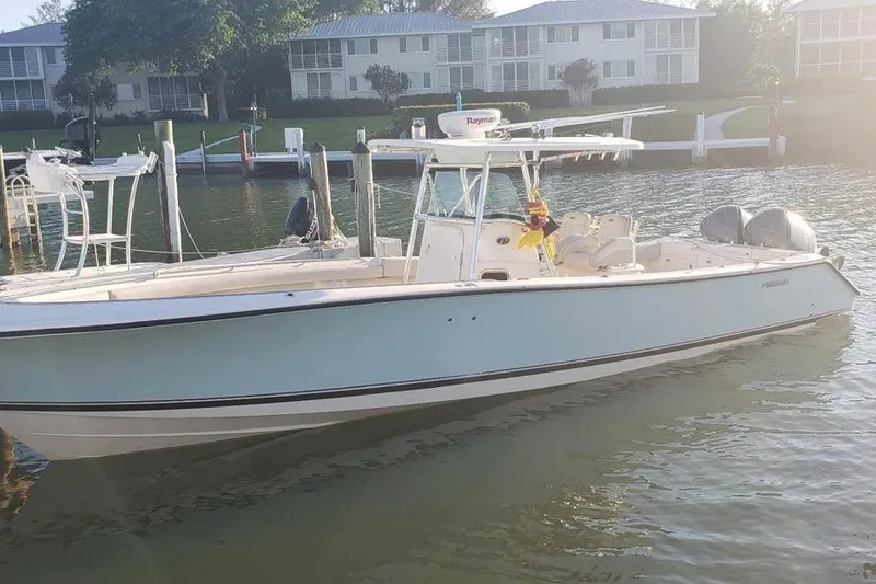 The Image of 2008 Pursuit C 340 Center Console boat docked in a serene marina setting. - 1