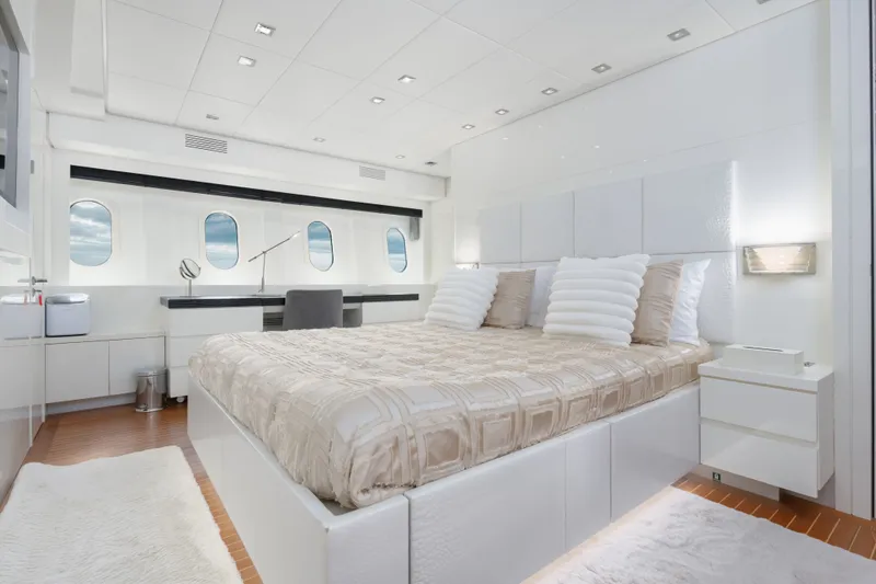 Slide: The Image of Luxurious bedroom interior on 2006 Arno Leopard 31 yacht, featuring elegant white decor. - 15