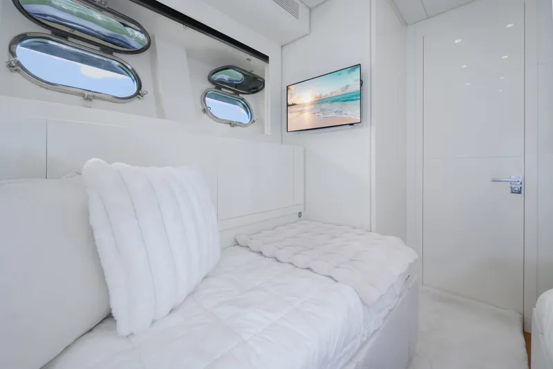 Slide: The Image of Luxurious white interior of 2006 Arno Leopard 31 yacht cabin with portholes and TV. - 22