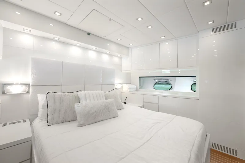 Slide: The Image of Luxurious white bedroom interior on 2006 Arno Leopard 31 yacht, featuring modern design and ample lighting. - 17