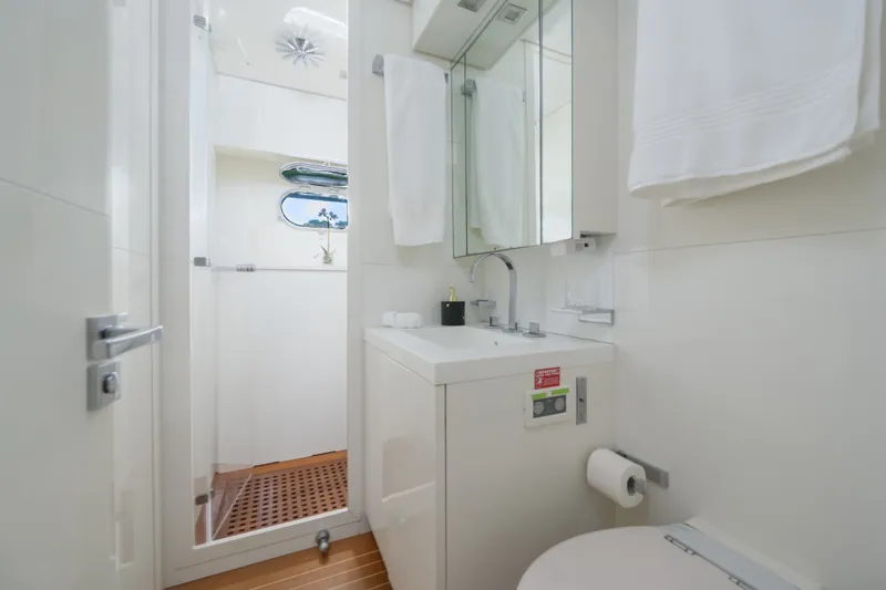 Slide: The Image of Luxurious yacht bathroom with modern fixtures, white decor, and wooden flooring on a 2006 Arno Leopard 31. - 18