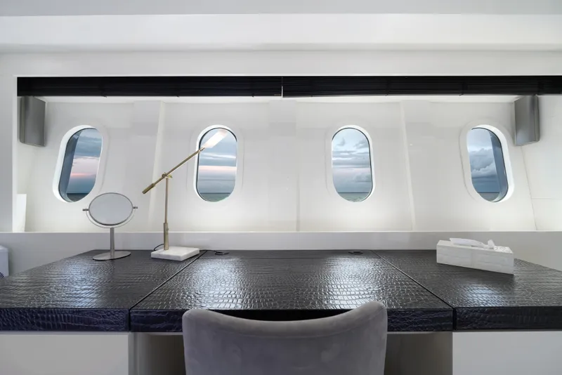 Slide: The Image of Luxurious yacht interior with desk, porthole windows, and ocean view on Arno Leopard 31, 2006 model. - 12