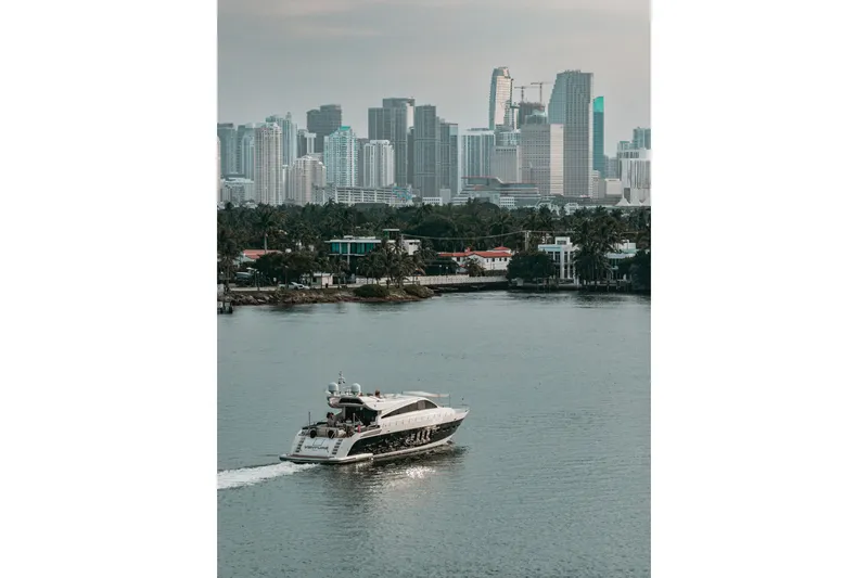 Slide: The Image of Luxury yacht Arno Leopard 31 cruising near city skyline, 2006 model. - 5