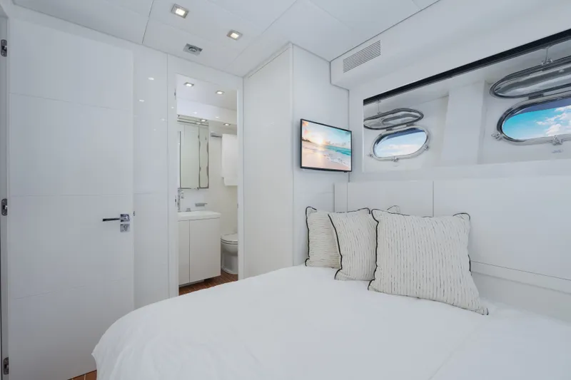 Slide: The Image of Luxurious cabin interior of 2006 Arno Leopard 31 yacht with modern decor and porthole windows. - 23