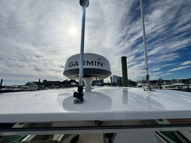 Slide: The Image of The image shows the roof of a 2016 Pursuit DC 325 Dual Console boat with a Garmin radar. - 27