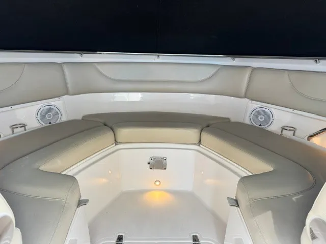 Slide: The Image of Interior view of a 2016 Pursuit DC 325 Dual Console boat with cushioned seating and speakers. - 21