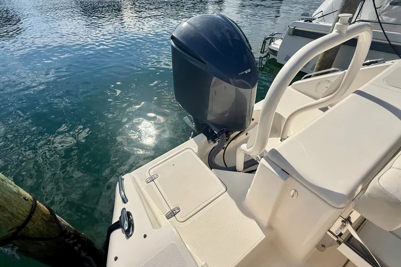 Slide: The Image of 2011 Pursuit DC 265 Dual Console boat with outboard motor on calm water. - 24