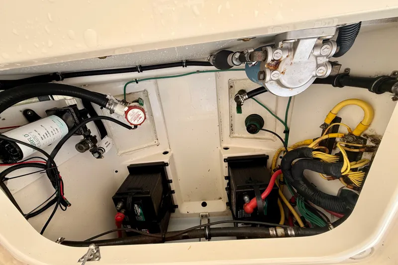 Slide: The Image of Engine compartment of a 2011 Pursuit DC 265 Dual Console boat, showing wiring and components. - 32