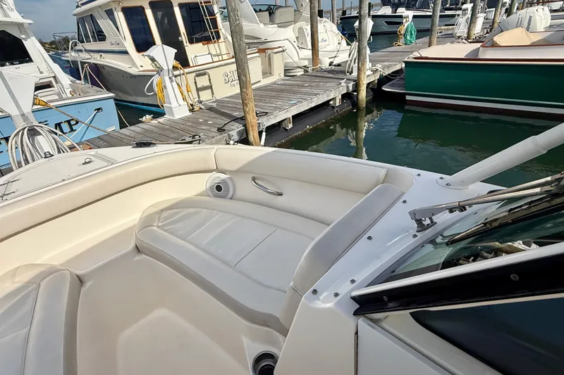 Slide: The Image of 2011 Pursuit DC 265 Dual Console boat docked at marina with other vessels. - 14