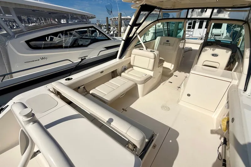 Slide: The Image of 2011 Pursuit DC 265 Dual Console boat interior with seating and storage. - 22