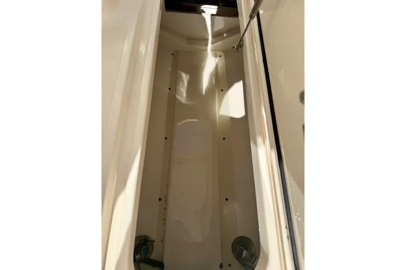 Slide: The Image of Storage compartment of a 2011 Pursuit DC 265 Dual Console boat. - 30