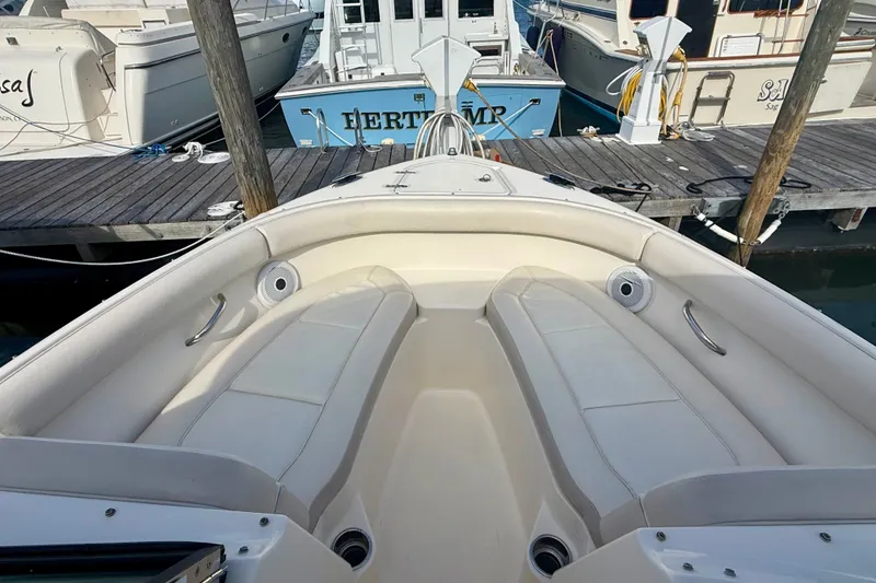 Slide: The Image of 2011 Pursuit DC 265 Dual Console boat docked, featuring spacious seating and sleek design. - 12