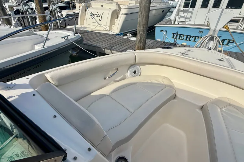Slide: The Image of 2011 Pursuit DC 265 Dual Console boat interior at marina dock. - 13
