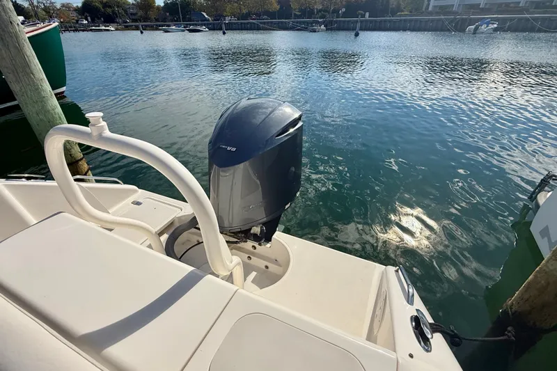 Slide: The Image of 2011 Pursuit DC 265 Dual Console boat with outboard motor on calm water. - 25