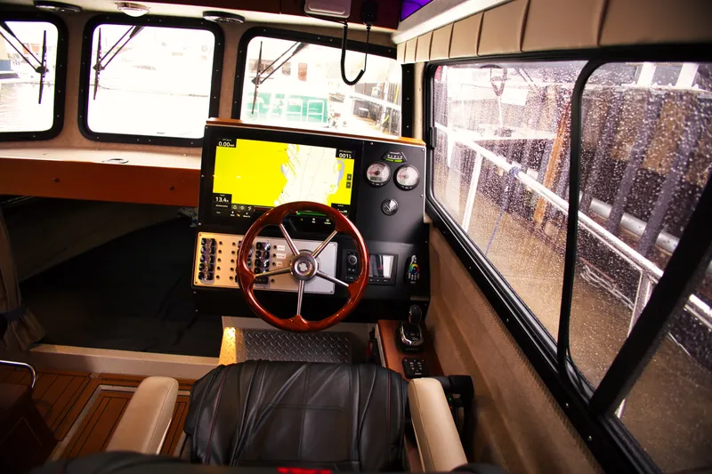 Slide: The Image of Interior view of a KingFisher 3425 GFX Offshore boat's helm with modern navigation equipment. - 13