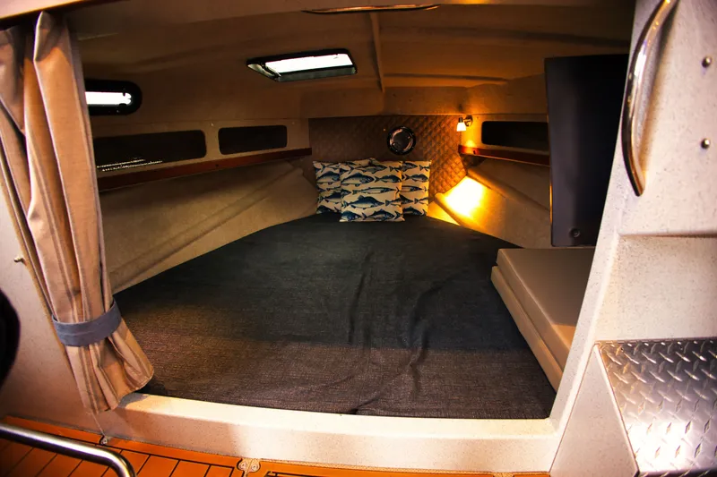 Slide: The Image of Interior of a 2022 KingFisher 3425 GFX Offshore with a cozy bed and lighting. - 16