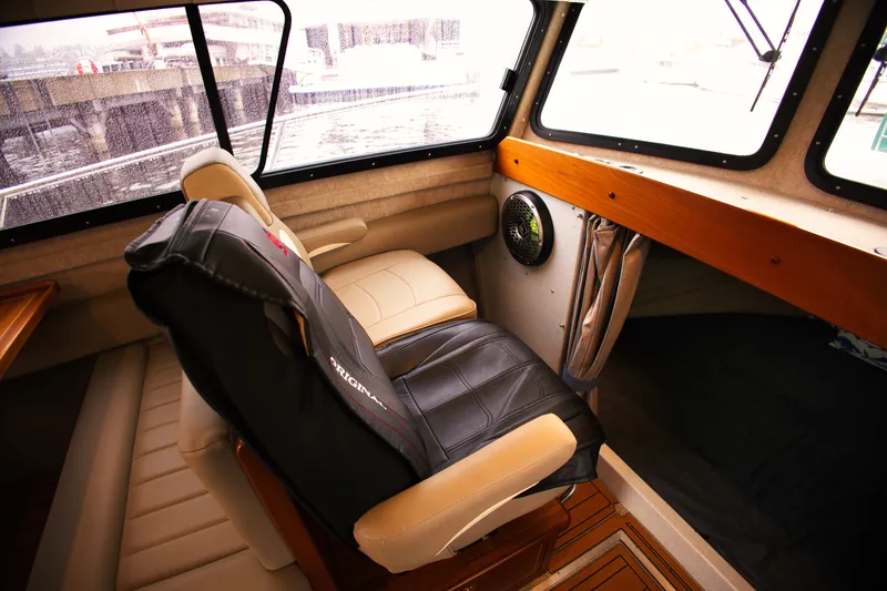 Slide: The Image of Interior of a 2022 KingFisher 3425 GFX Offshore with comfortable seating and large windows. - 18