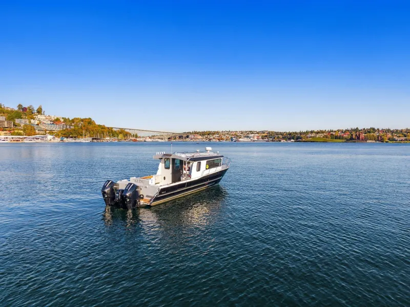 Slide: The Image of KingFisher 3425 GFX Offshore 2022 on calm water with cityscape in the background. - 22