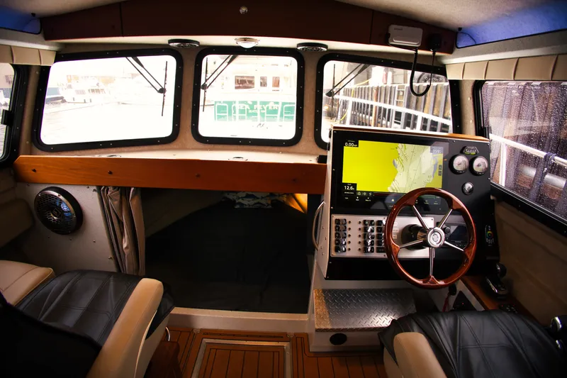 Slide: The Image of Interior of the 2022 KingFisher 3425 GFX Offshore with modern controls and comfortable seating. - 14
