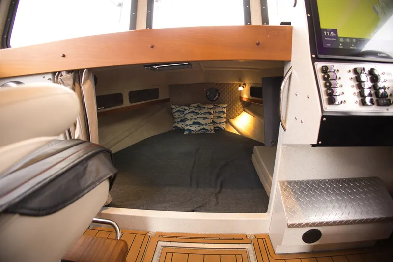 Slide: The Image of Interior of the 2022 KingFisher 3425 GFX Offshore with cozy cabin and helm console. - 17