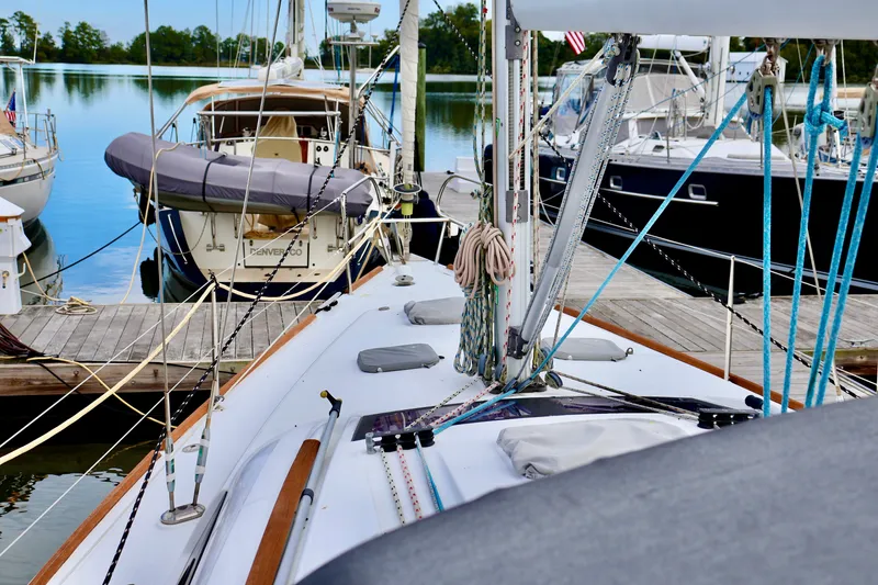 Slide: The Image of Sailboat docked with several other boats in the background. - 27