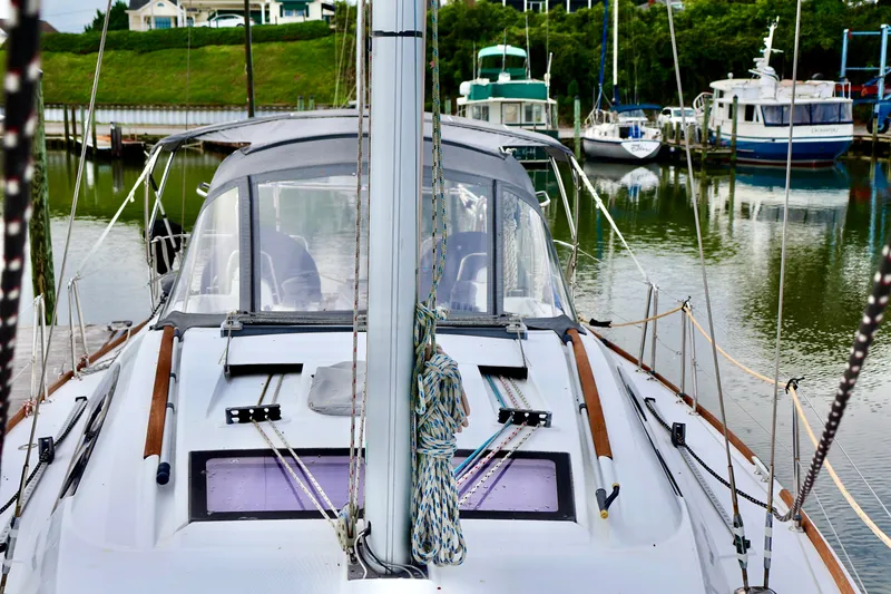 Slide: The Image of 2011 Beneteau 40 sailboat docked in a marina, surrounded by other boats. - 26