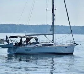 The Image of 2011 Beneteau 40 sailboat on calm water with people on board. - 0