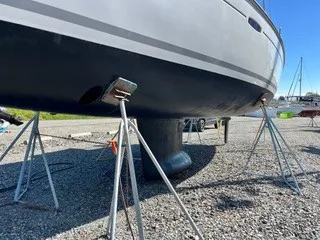 Slide: The Image of A 2011 Beneteau 40 is supported on stands on land. - 31