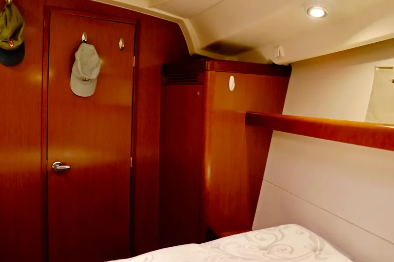 Slide: The Image of Interior of a 2011 Beneteau 40 with wooden doors and a cozy bed. - 13