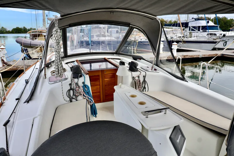 Slide: The Image of The image shows the cockpit of a 2011 Beneteau 40 docked at a marina. - 23
