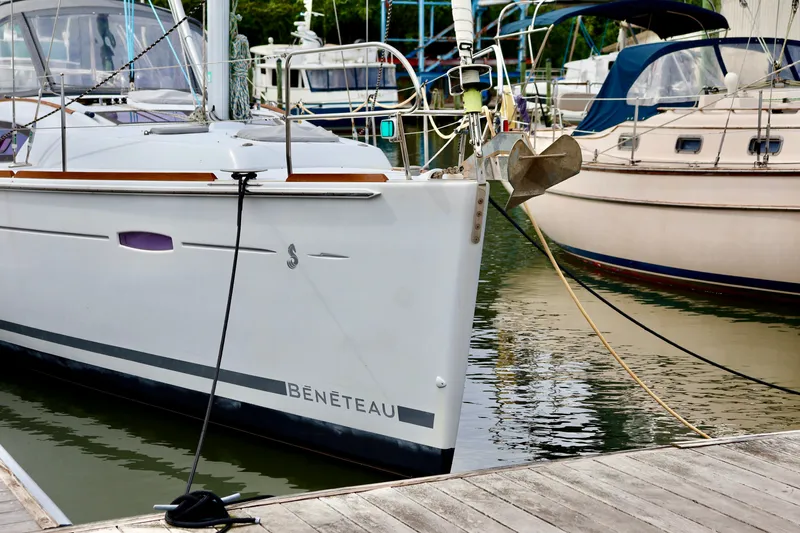 Slide: The Image of A 2011 Beneteau 40 docked in a marina, surrounded by other boats. - 29