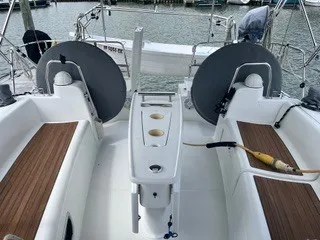 Slide: The Image of The cockpit of a 2011 Beneteau 40 with wooden benches and steering wheels. - 3