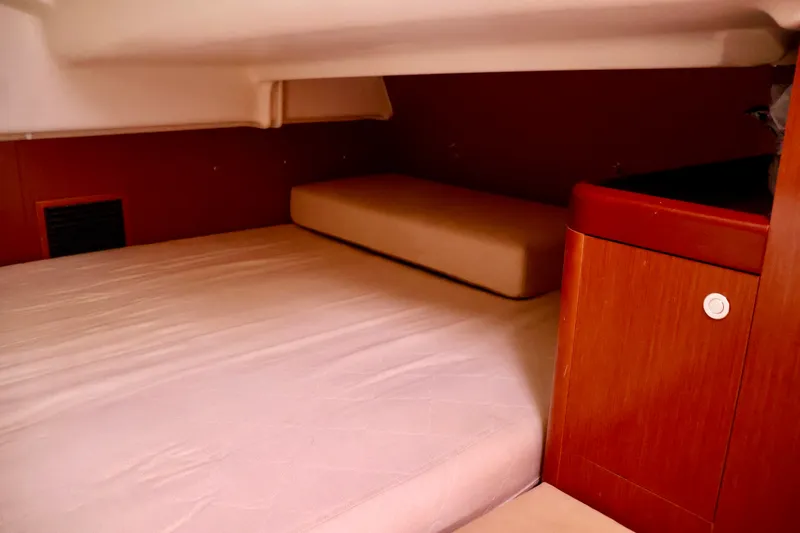 Slide: The Image of Interior of a 2011 Beneteau 40 featuring a cozy sleeping area. - 20