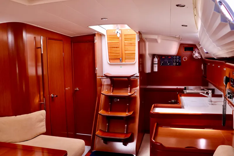 Slide: The Image of Interior of a 2011 Beneteau 40 with wooden furnishings and a staircase leading to the hatch. - 18