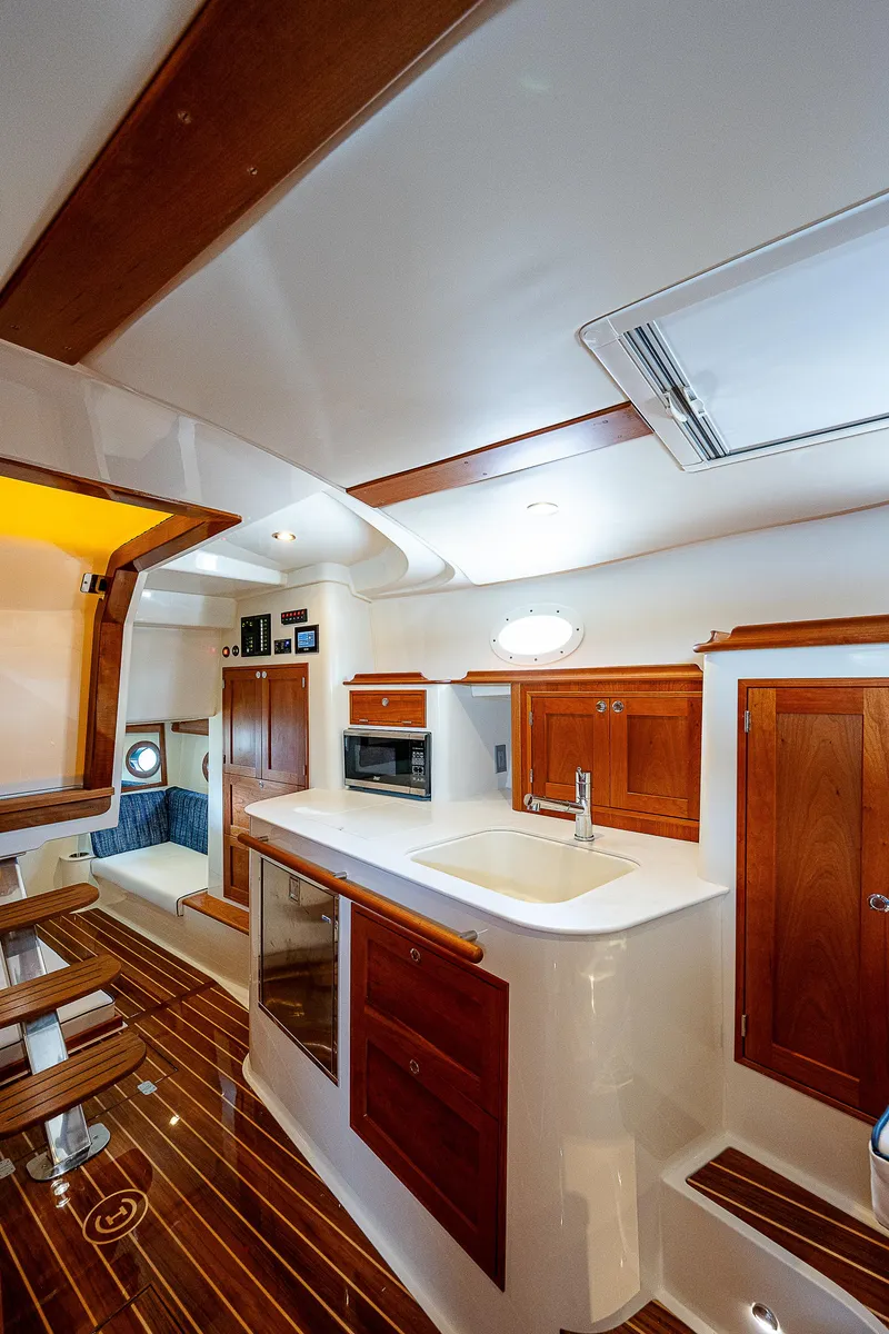 Slide: The Image of Innenraum einer luxuriösen Yacht mit Holzböden, weißen Oberflächen und eleganten Holzschränken. - 19
