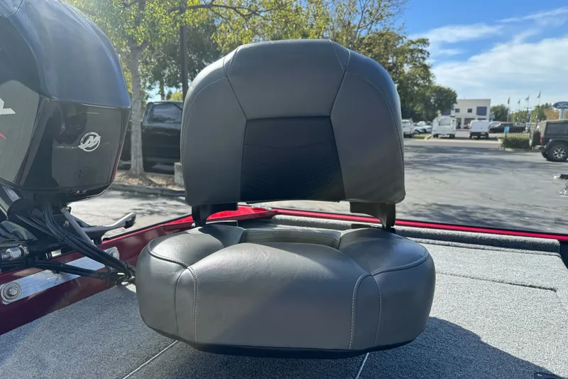 Slide: The Image of 2025 Tracker Bass Tracker Classic XL boat seat with motor, outdoors in sunny setting. - 14